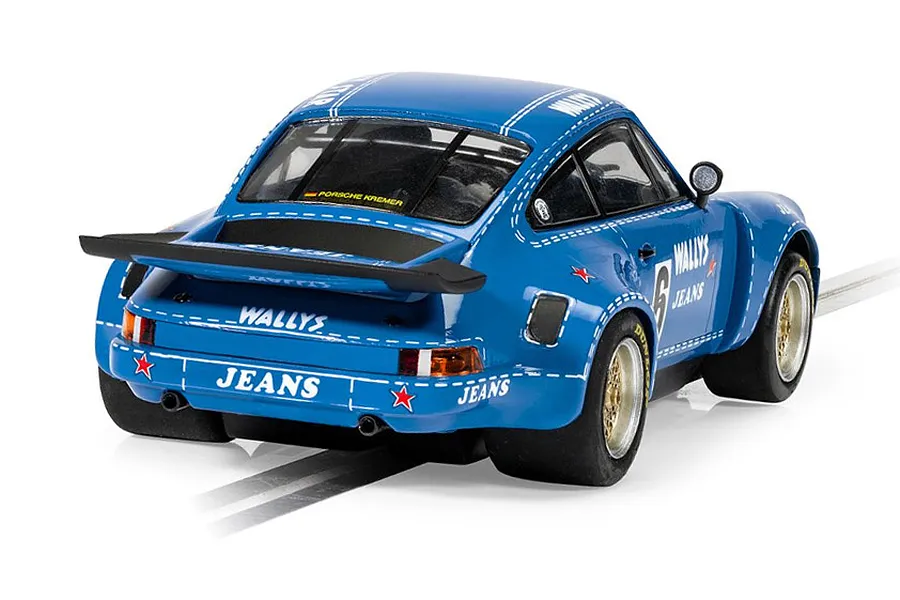 Rear three-quarter view of a blue Scalextric 1/32 scale Porsche 911 Carrera RSR 3.0 Wallys Jeans slot car on a track.