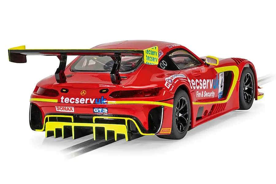Rear three-quarter view of a red Scalextric Mercedes AMG GT3 EVO slot car with yellow accents and Tecserv UK branding on a track.