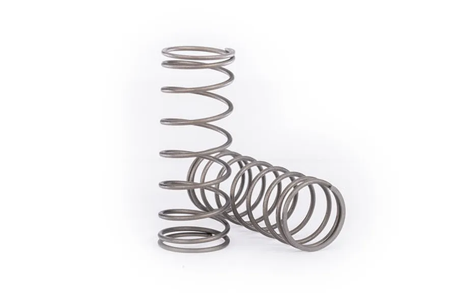 Two grey metal coil springs for RC car suspension, one standing upright and one lying horizontally on a white background.