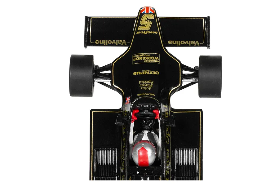 Top-down view of a black and gold Scalextric 1/32 scale Lotus 79 slot car with racing livery and a driver figure.