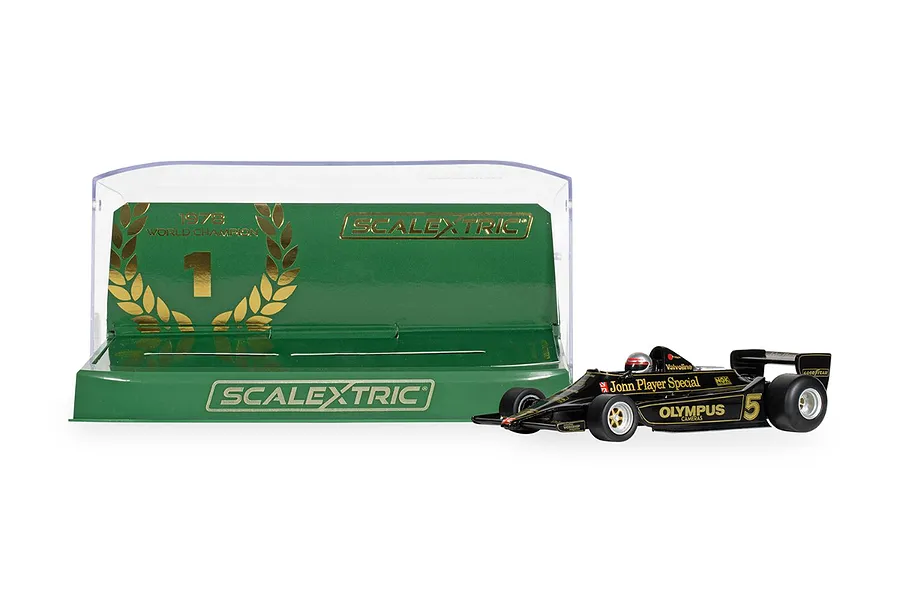 A Scalextric 1/32 scale 1978 Lotus 79 slot car in black and gold livery, displayed next to its green and gold display case.
