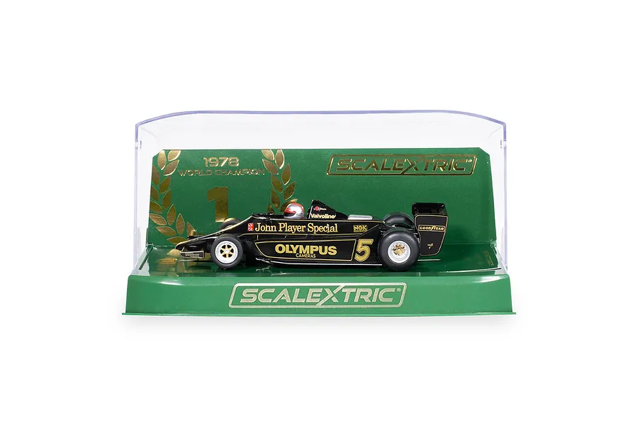 A 1/32 scale Scalextric Lotus 79 slot car in black and gold livery, displayed in its original green and clear plastic display case.