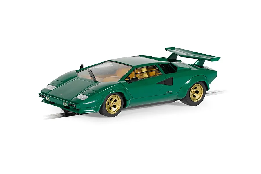 A 1/32 scale Scalextric Lamborghini Countach slot car in green with gold wheels, positioned on a slot car track against a white background.