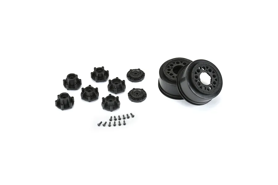 Two black Pro-Line short course RC rims with multiple hex adapters and small mounting screws on a white background.