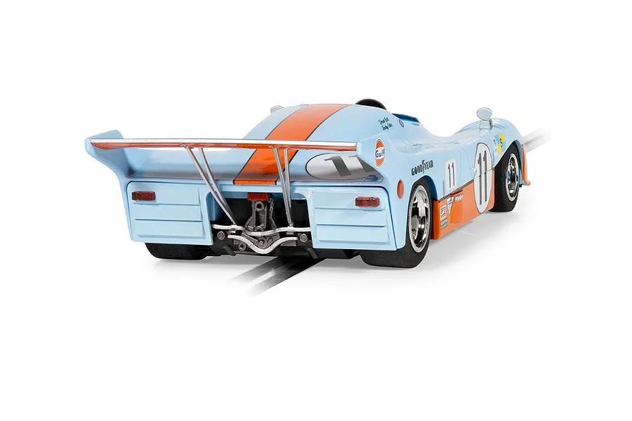 Rear three-quarter view of a light blue and orange Scalextric 1975 Mirage GR8 slot car with number 11 livery on a white background.