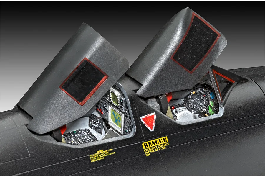 Close-up of the detailed tandem cockpits of a Revell 1/48 scale SR-71A Blackbird model kit with open canopies.