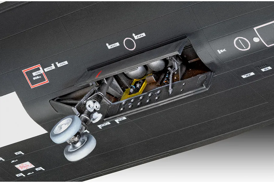 Close-up of the landing gear bay and wheels on a black plastic model SR-71 Blackbird aircraft.