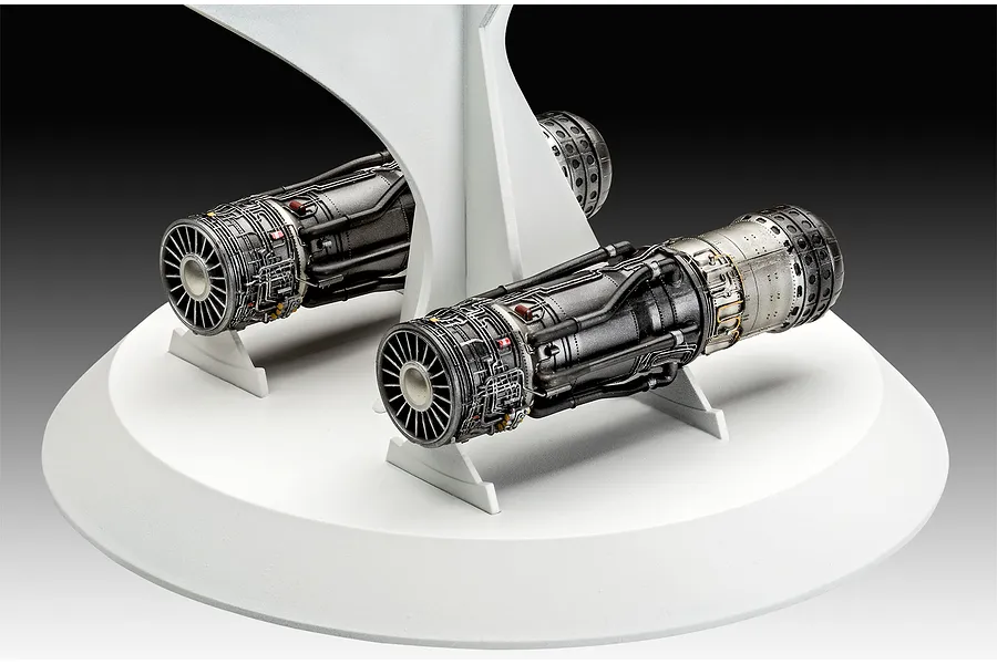 Two highly detailed scale model jet engines for an SR-71 Blackbird displayed on a white circular stand against a dark background.
