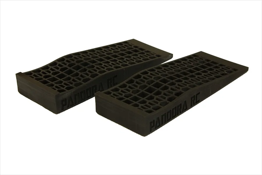 Two black unpainted 1/10 scale RC tyre slopes by Pandora RC with a honeycomb pattern surface.