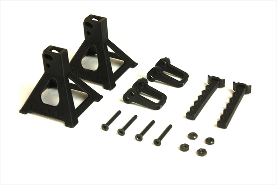 A set of unpainted black plastic 1/10 scale RC car jack stands by Pandora RC, including bases, adjustable supports, screws, and nuts.