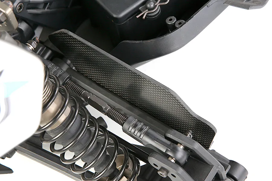 Close-up of a carbon fibre suspension arm guard installed on an RC vehicle chassis.