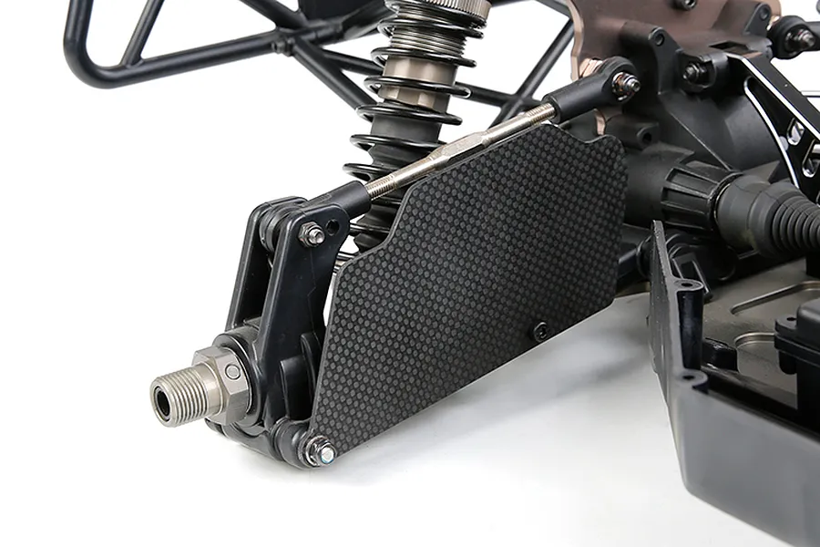Carbon fibre rear suspension arm guard installed on an RC car chassis, showing the weave pattern and mounting hardware.