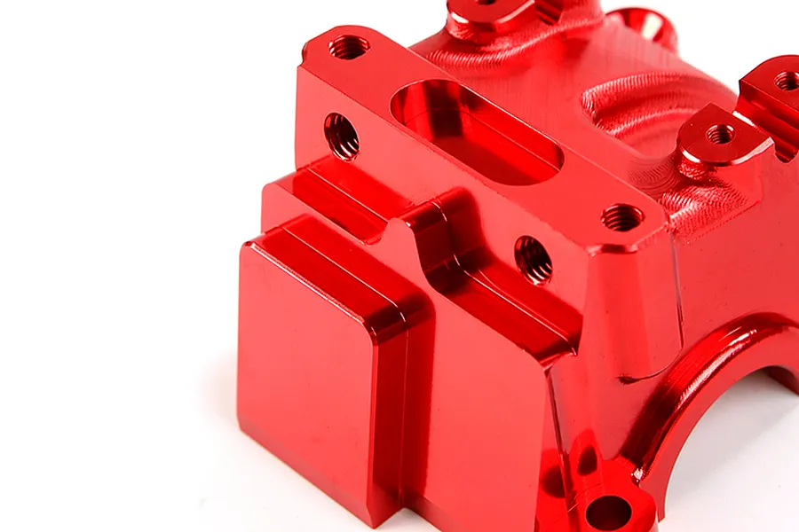 A close-up view of a bright red anodized aluminium RC gearbox case component.