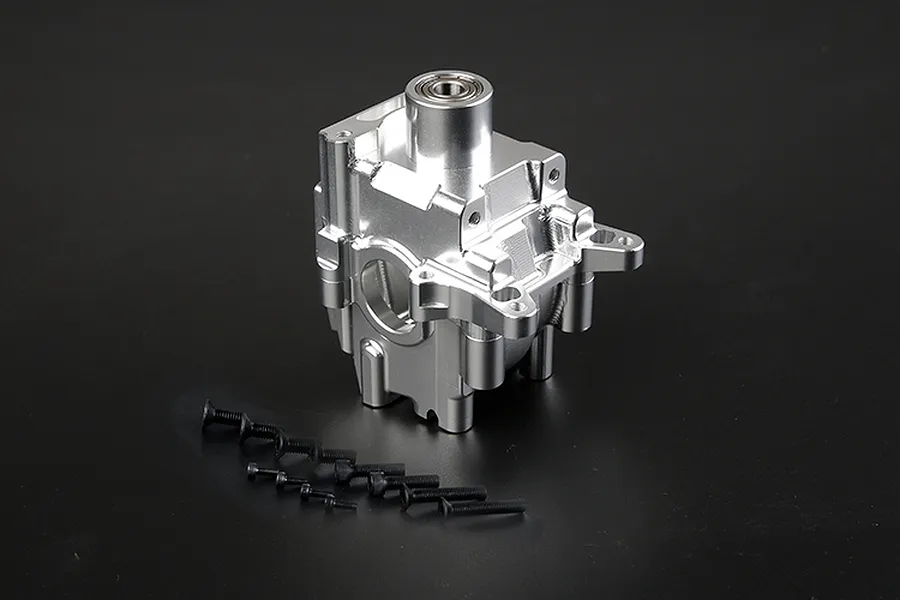 A silver Rovan aluminium gearbox case for an RC car, shown with a set of black mounting screws on a dark background.