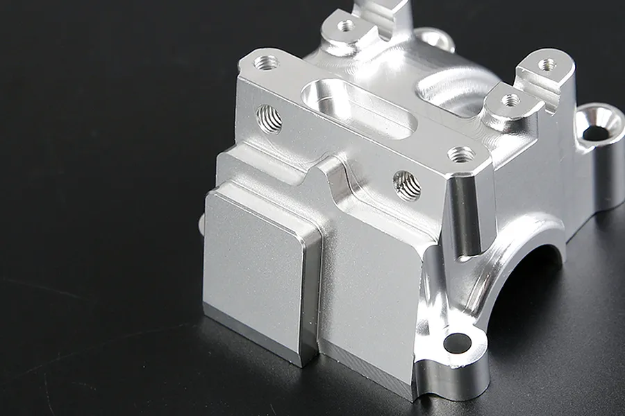 A silver Rovan aluminium gearbox case for an RC car, shown from a high angle against a dark background.