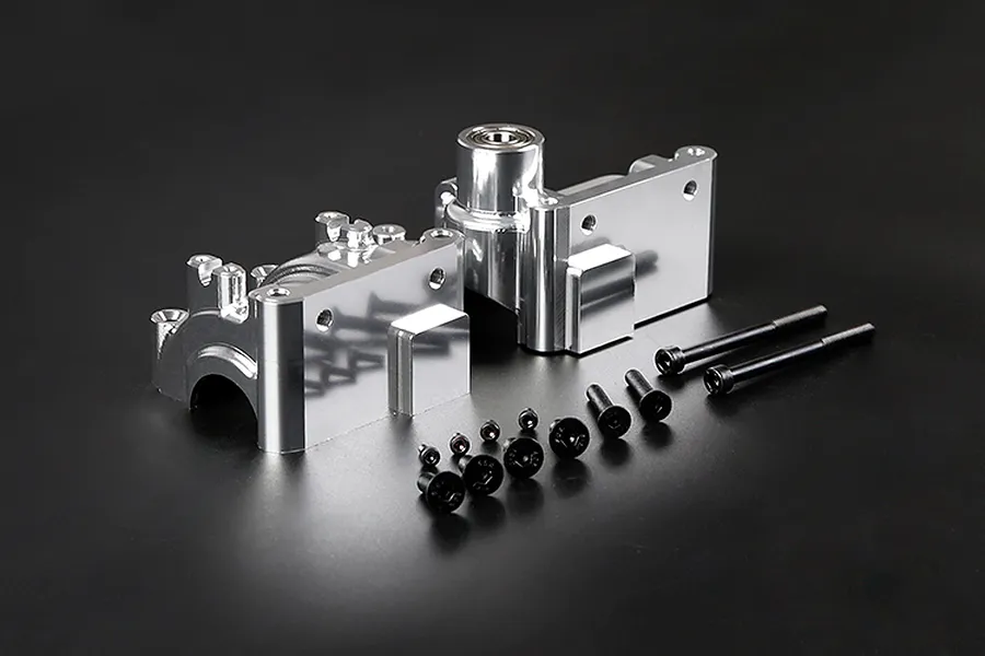 Silver Rovan aluminium gearbox case set with included screws and ball bearing on a black background.