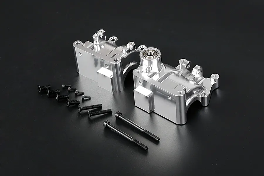 Rovan silver aluminium gearbox case halves with included black screws and bolts on a dark background.
