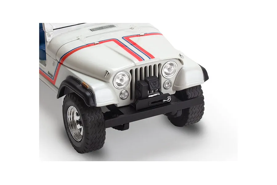 Close-up of the front end of a white 1977 Jeep CJ-7 plastic model kit featuring red and blue hood stripes and a black front bumper with a winch.