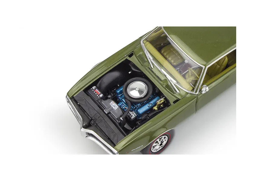 A high-angle view of a 1/25 scale model 1968 Pontiac Firebird with the hood open, revealing a detailed blue engine bay and olive green exterior.