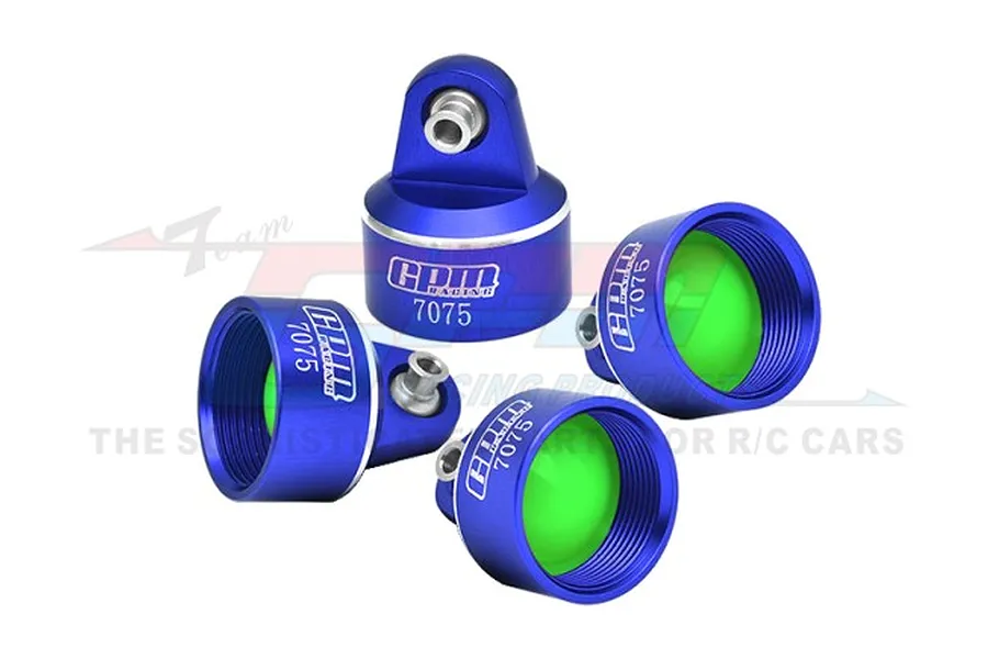 Four blue anodized aluminium RC shock absorber caps from GPM Racing, featuring a 7075 alloy marking and bright green internal seals.
