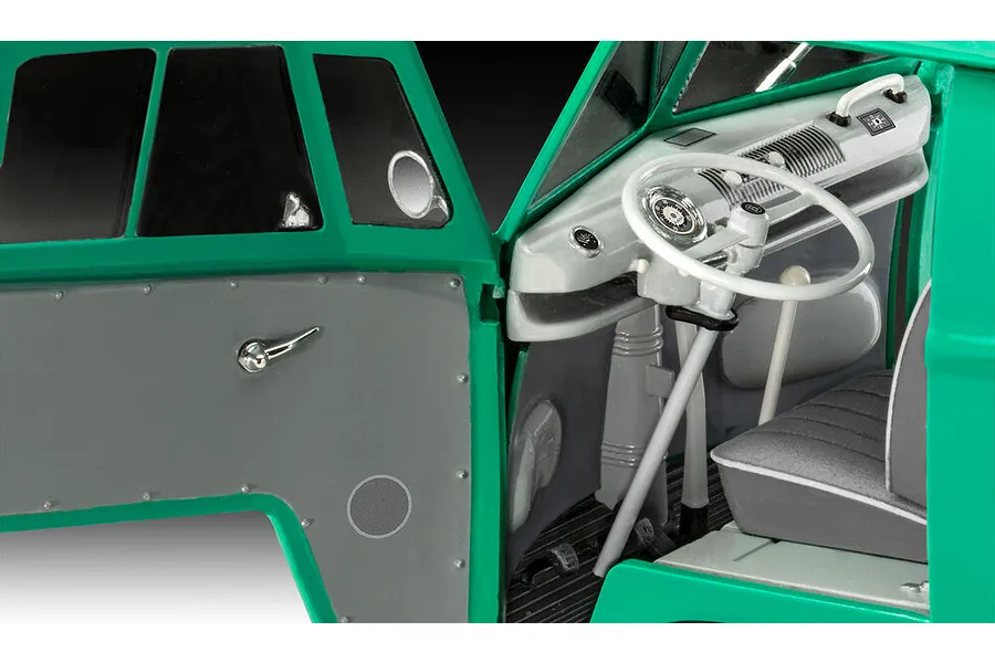 Close-up interior view of a 1/24 scale Revell VW T1 Bus model kit showing the dashboard, steering wheel, and driver side door panel.