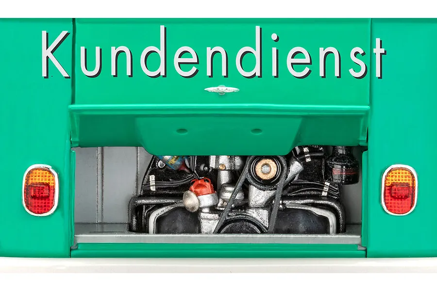 Close-up of the rear engine bay of a teal VW T1 model bus with the word Kundendienst printed above the open engine compartment.