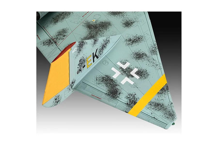 Close-up of the wing section of a scale model Arado Ar E.555 bomber, featuring a light blue camouflage pattern with black mottling, yellow markings, and German military insignia.