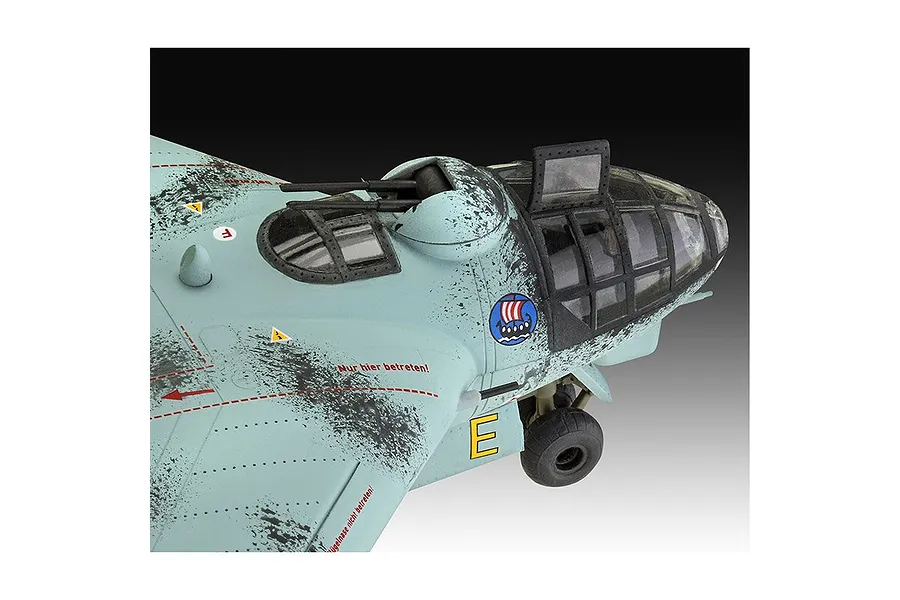 Close-up of a 1/72 scale plastic model of an Arado Ar E.555 bomber, showing the cockpit, nose turret, and weathered light blue camouflage paint.