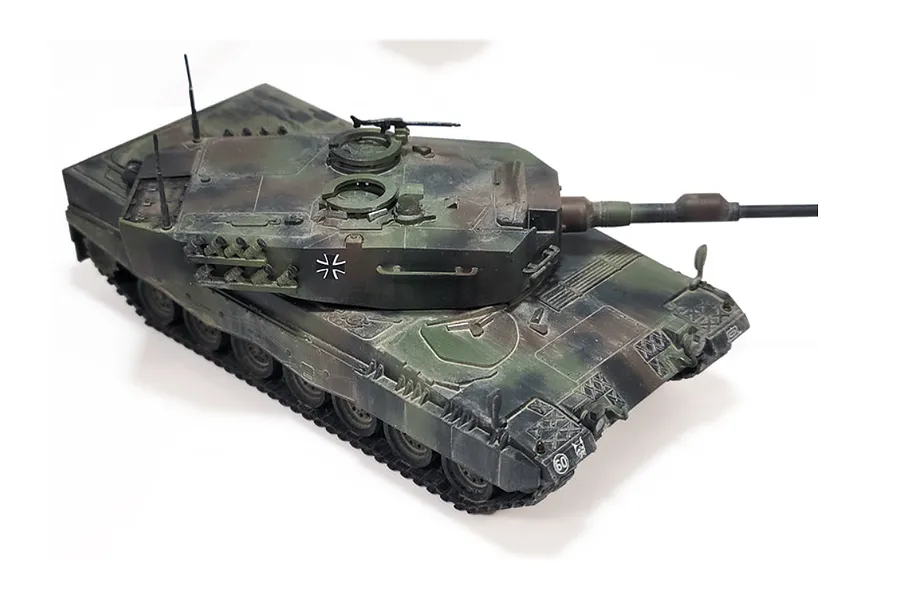 A high-angle view of an assembled and painted 1/72 scale Leopard 2A4 tank model with a camouflage paint scheme on a white background.