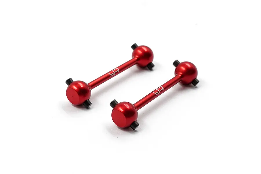 Two red anodized aluminium RC driveshafts with black cross pins, featuring the Yeah Racing logo laser-etched on the shafts, set against a white background.