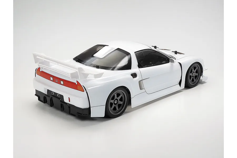 A rear three-quarter view of a white Tamiya 1998 Honda NSX RC car model on a plain white background.
