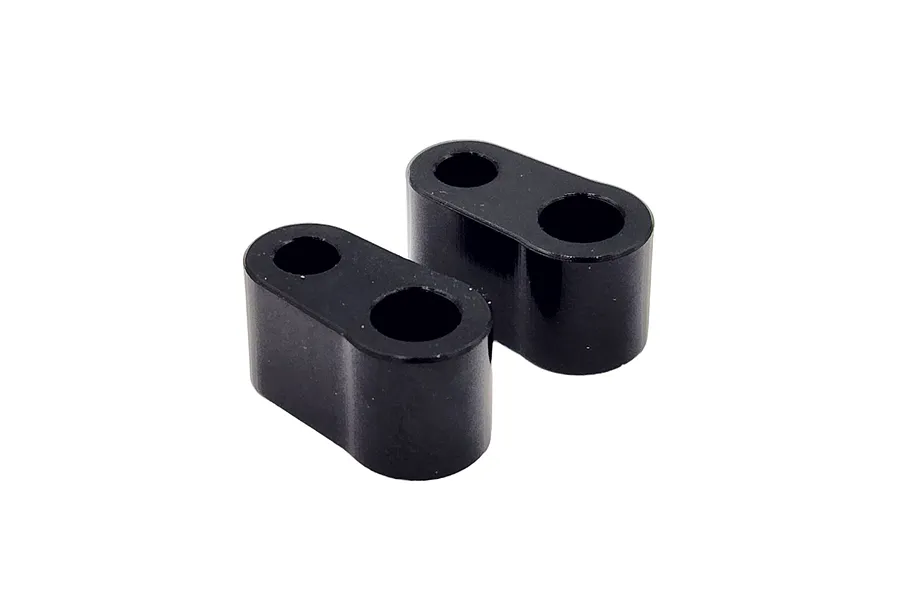 Two black RC Maker rear body mount spacers with two holes each, shown against a white background.