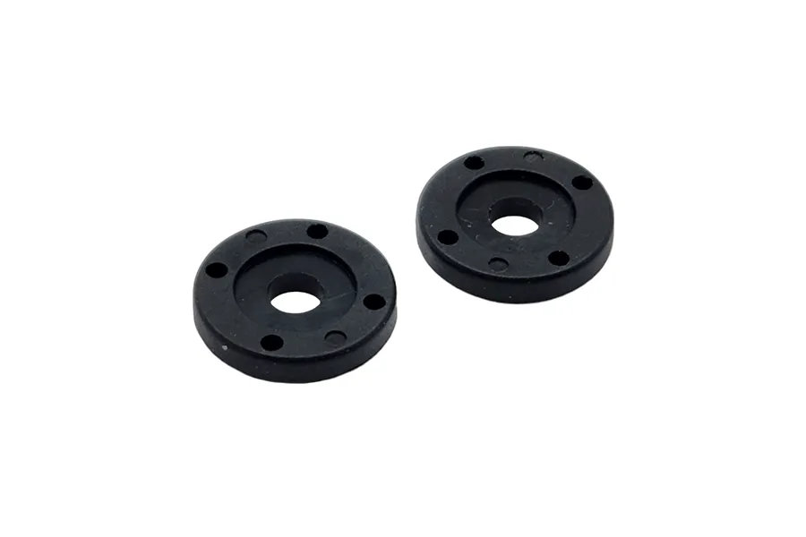 Two black circular RC shock pistons with four small holes each, isolated on a white background.