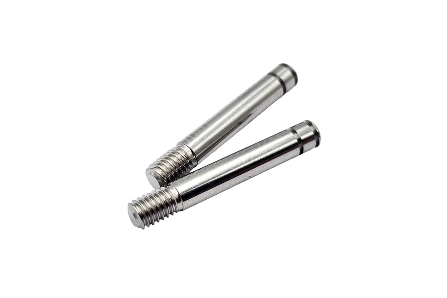 Two polished metal RC shock shafts with threaded ends and a small groove near the top, isolated against a white background.