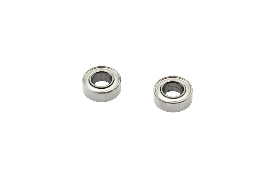 Two small metal shielded ball bearings isolated on a white background.