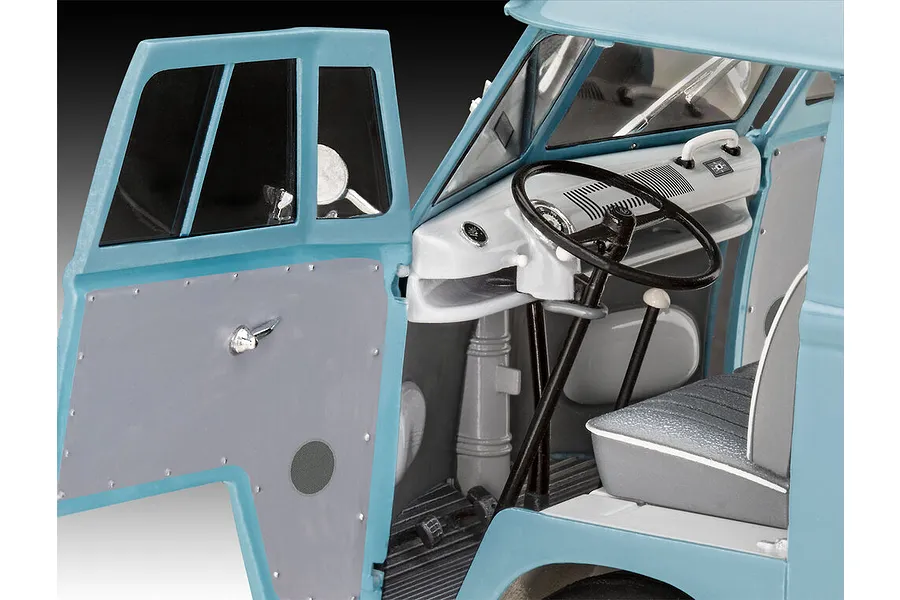 Close-up of the interior of a 1/24 scale Revell Volkswagen T1 Gulf model van, showing the dashboard, steering wheel, and open driver-side door.