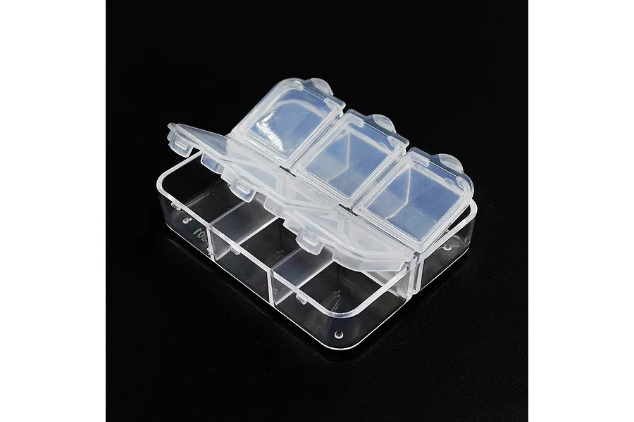 A clear plastic storage box with six compartments, featuring individual hinged lids, set against a black background.