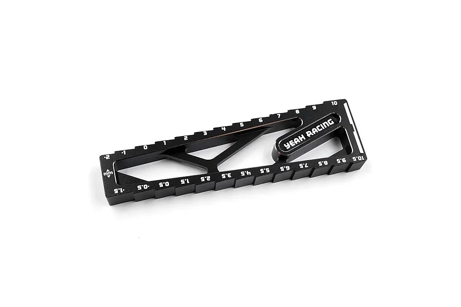 A black anodized aluminum Yeah Racing droop gauge for RC cars, featuring laser-etched measurement markings from -2 to 10.5 mm.