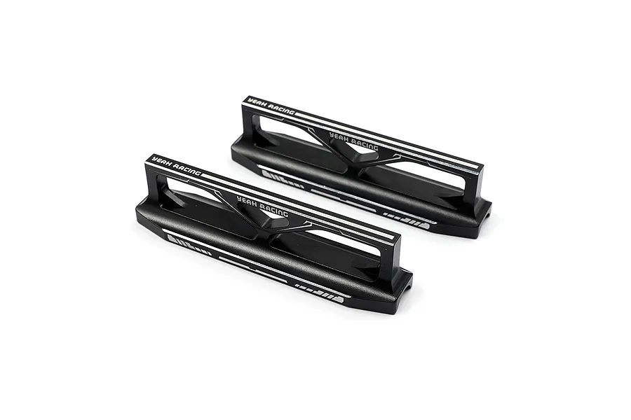 Two black aluminum Yeah Racing droop blocks for RC car setup, featuring white laser-etched branding and markings on a white background.