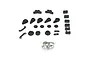 A set of black plastic RC servo saver and steering components laid out on a white background with a small bag of metal rings.