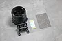 Pandora RC steering wheel upgrade kit for Sanwa transmitters, including a black wheel, mounting bracket, adhesive strip, and brake disc decals.