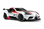 A 1/10 scale Traxxas Toyota GR Supra GT4 RC car in white, red, and black racing livery, viewed from a front three-quarter angle against a white background.