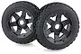 Two Rovan 1/5 scale Baja 5B front wheels with black rims and Dirt Buster off-road tyres, featuring a beadlock design.
