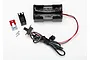 Traxxas AA battery holder with an integrated power switch, including mounting hardware and a faceplate on a white background.
