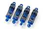 Four blue and black RC shock absorbers arranged in a row against a white background.