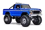 A studio shot of a blue Traxxas TRX-4 1979 Ford F-150 High Trail Edition RC rock crawler on a white background.