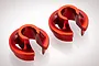 Two red anodized aluminium RC shock spring retainers shown from a high angle on a white background.