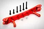 A red anodized aluminium rear shock tower brace for an RC car, accompanied by six black bolts and two silver spacers.