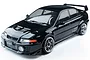 A studio shot of a black 1/10 scale MST RMX 2.5 Mitsubishi Evolution V RC drift car body on a white background.