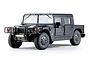 A studio shot of a black FMS 1/12 scale 2006 Hummer H1 Alpha RC rock crawler truck on a white background.
